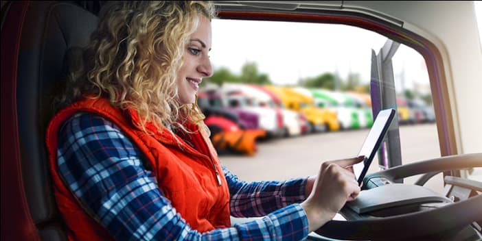 Driver using tablet to identify recommended loads.